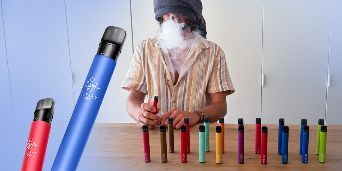 ELFBAR 600 Einweg Vape in mehreren Farben, 20 mg Nikotin, mit dampfender Person am Tisch und aufgereihten Geräten